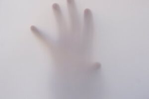 person s hand touching wall