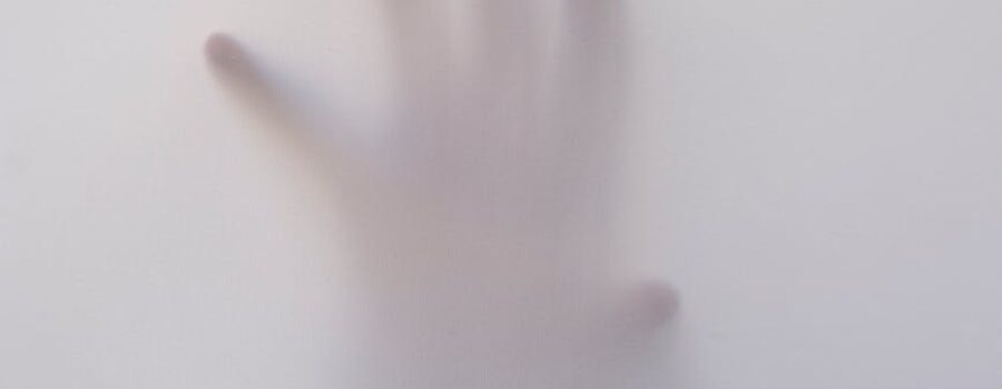 person s hand touching wall