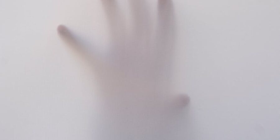 person s hand touching wall