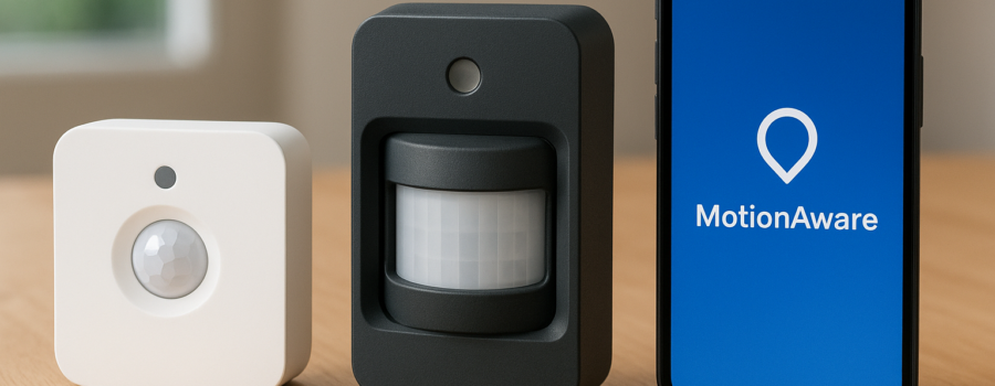 Two Philips Hue motion sensors beside a smartphone showing the MotionAware app on a wooden surface.