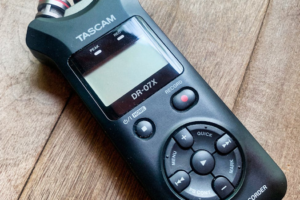 Tascam DR-07X portable audio recorder on a wooden surface