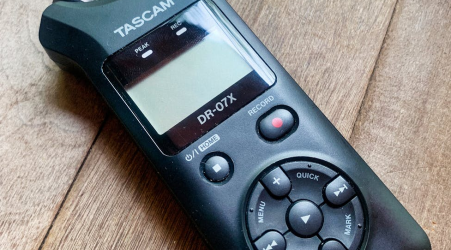 Tascam DR-07X portable audio recorder on a wooden surface