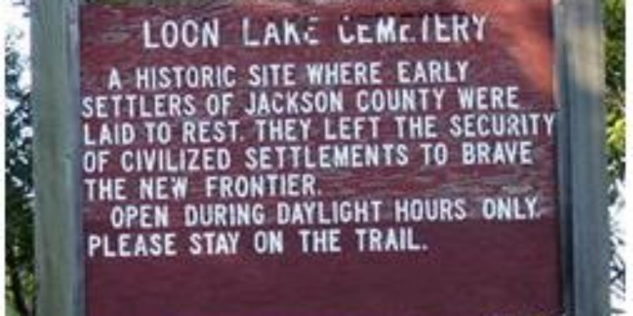 Historic Loon Lake Cemetery sign marking early settlers' burial site in Jackson County.