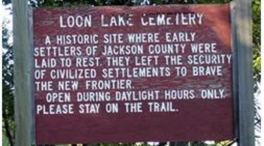 Historic Loon Lake Cemetery sign marking early settlers' burial site in Jackson County.