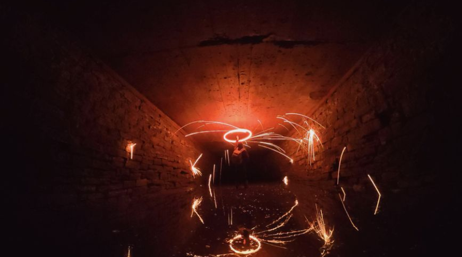 Abstract light trails in a dark tunnel, captured with long exposure