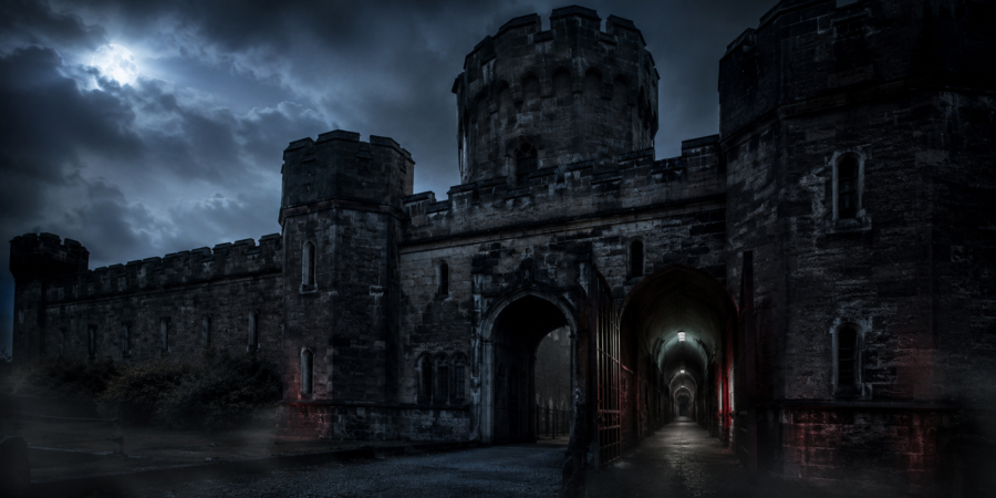Dark medieval castle entrance under a stormy night sky, eerie and foreboding