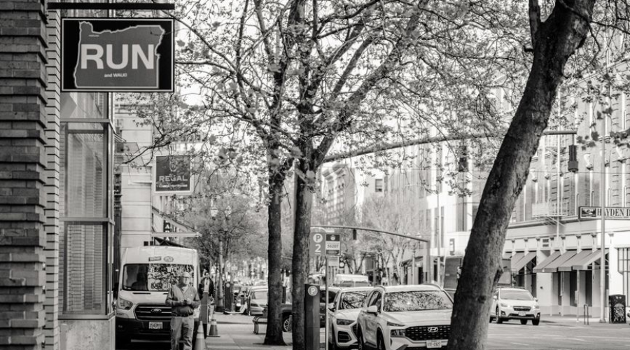 Black and white Portland street scene with RUN sign and parked cars