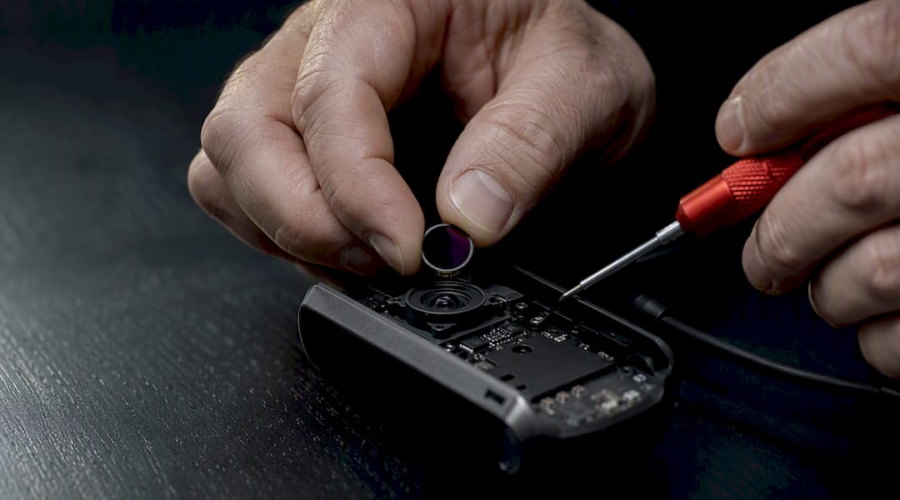 Technician removing IR filter from webcam