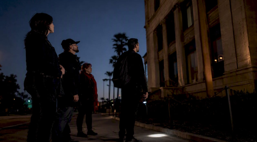 Investigators viewing historic building from public sidewalk